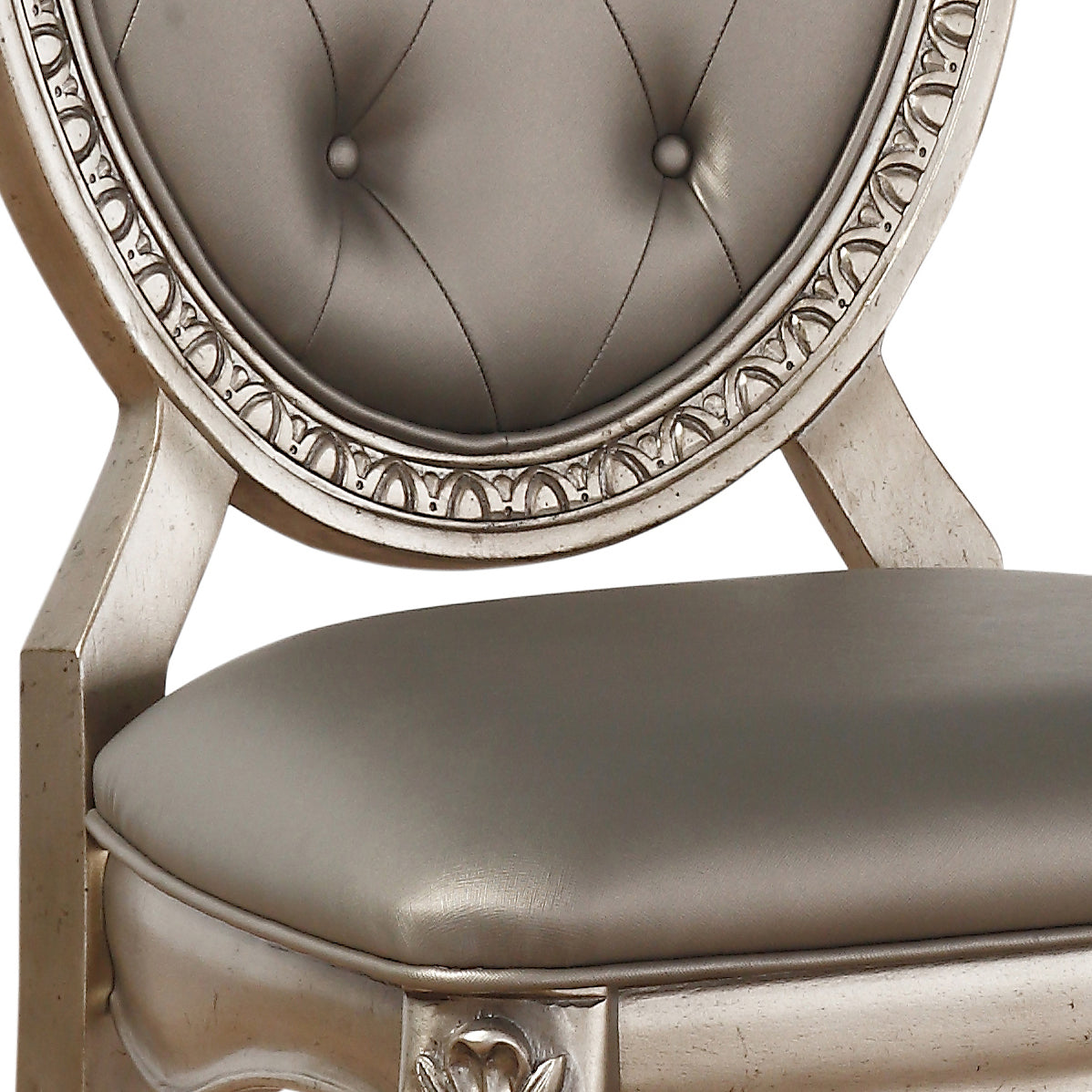 Tufted silver upholstered accent chair with ornate carved wood frame