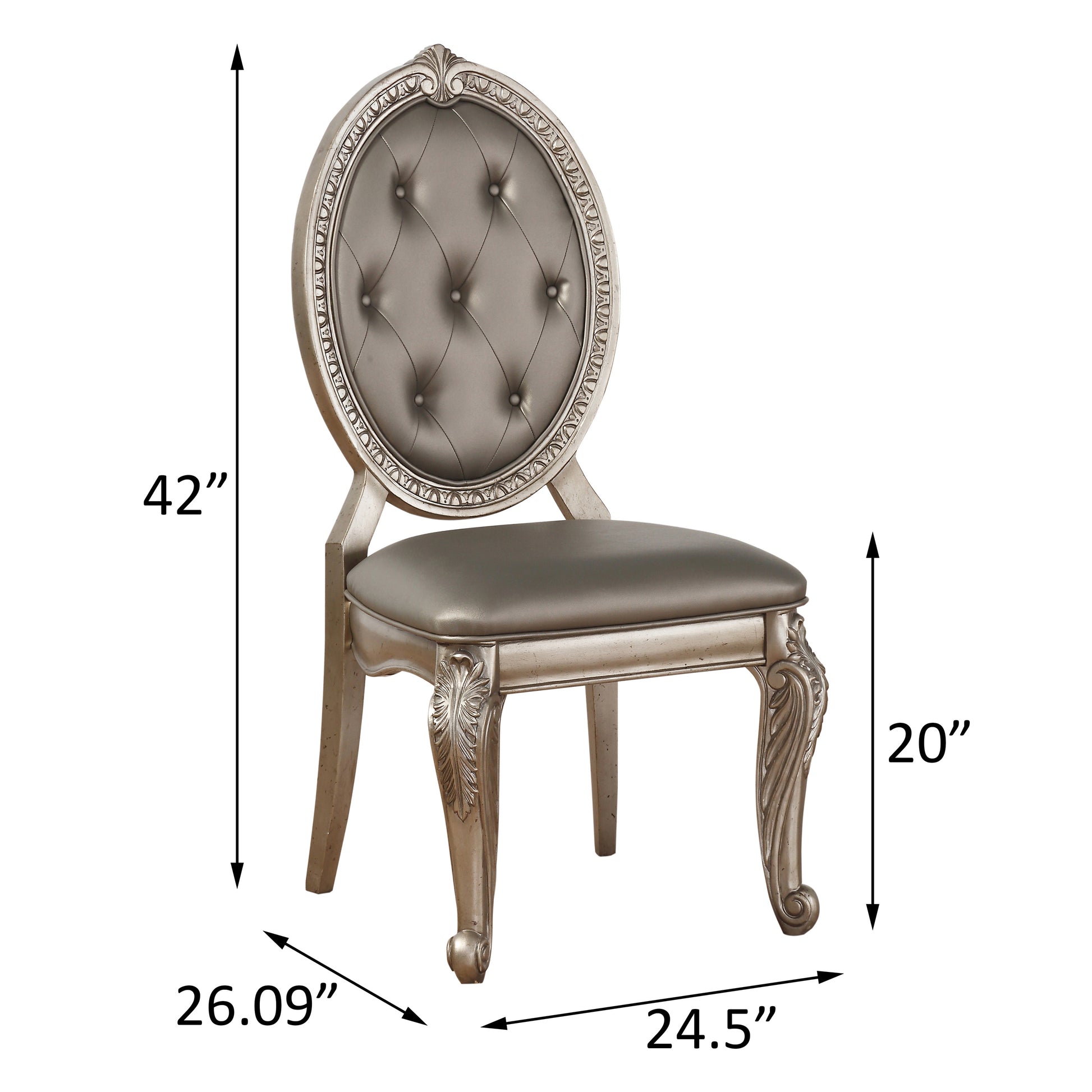 Silver tufted upholstered dining chair with ornate carved details on the frame