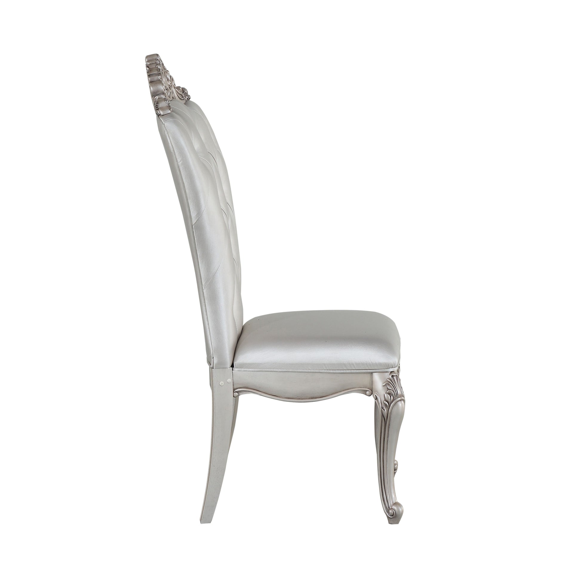 Ornate silver upholstered dining chair with tufted back and scrolled legs