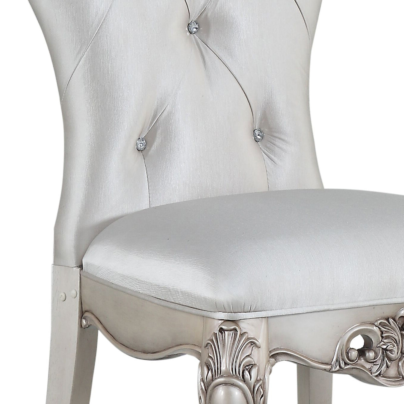 Elegant white tufted accent chair with crystal buttons and carved wooden legs