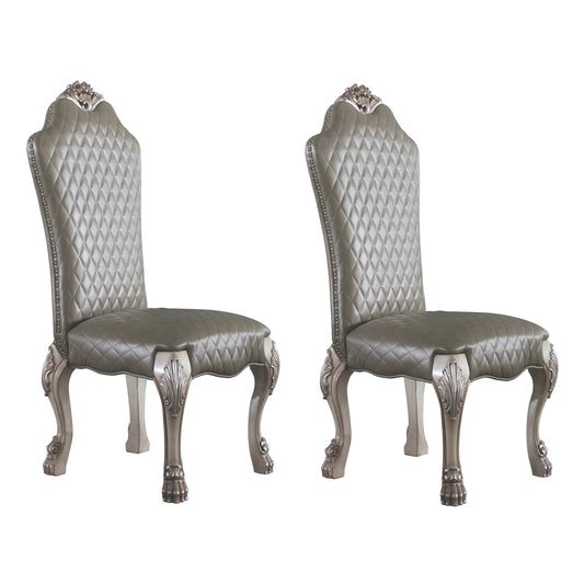 Two ornate grey tufted velvet dining chairs with silver antique legs