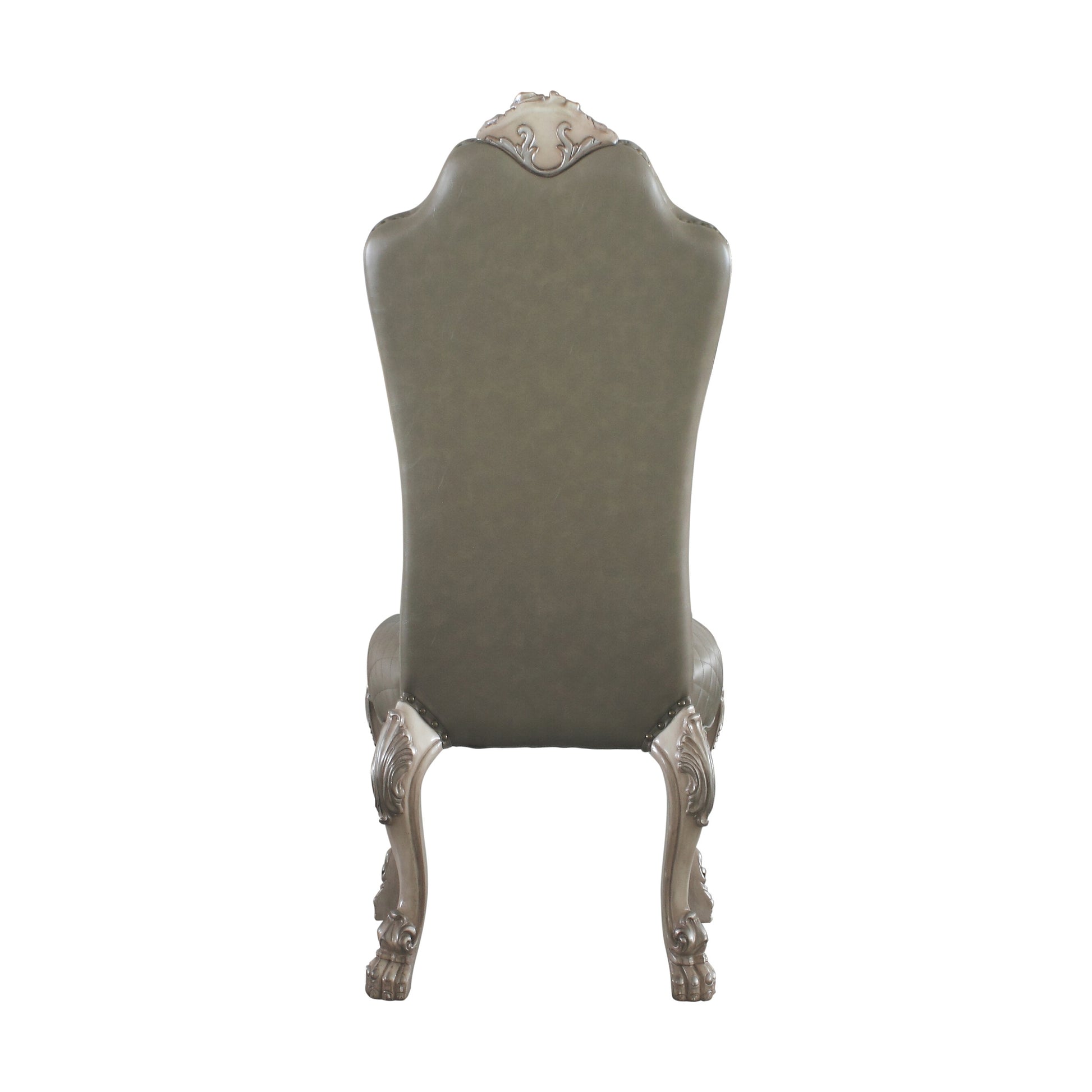 Back view of a grey tufted leather dining chair with ornate carved wooden legs