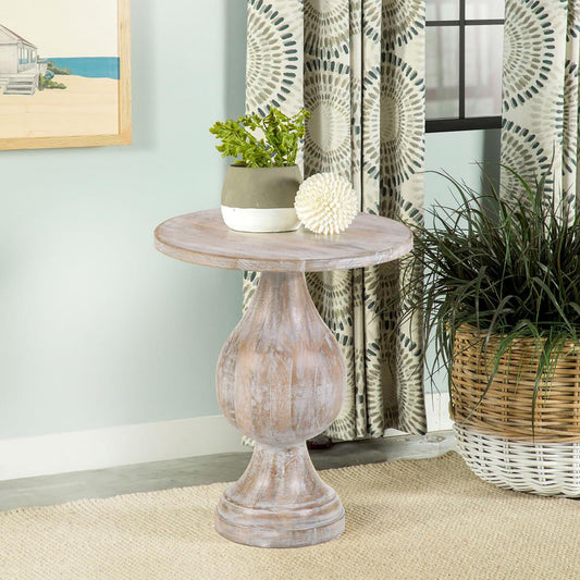 Distressed wood accent table with carved pedestal base
