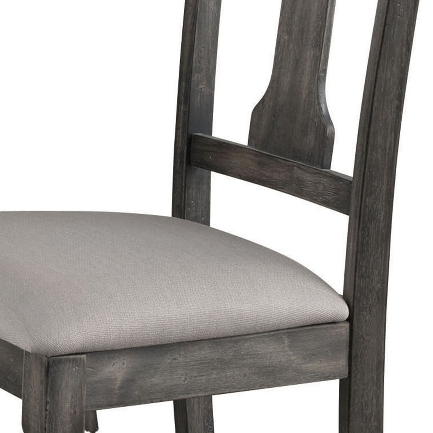 Closeup of upholstered seat on a distressed grey wood dining chair
