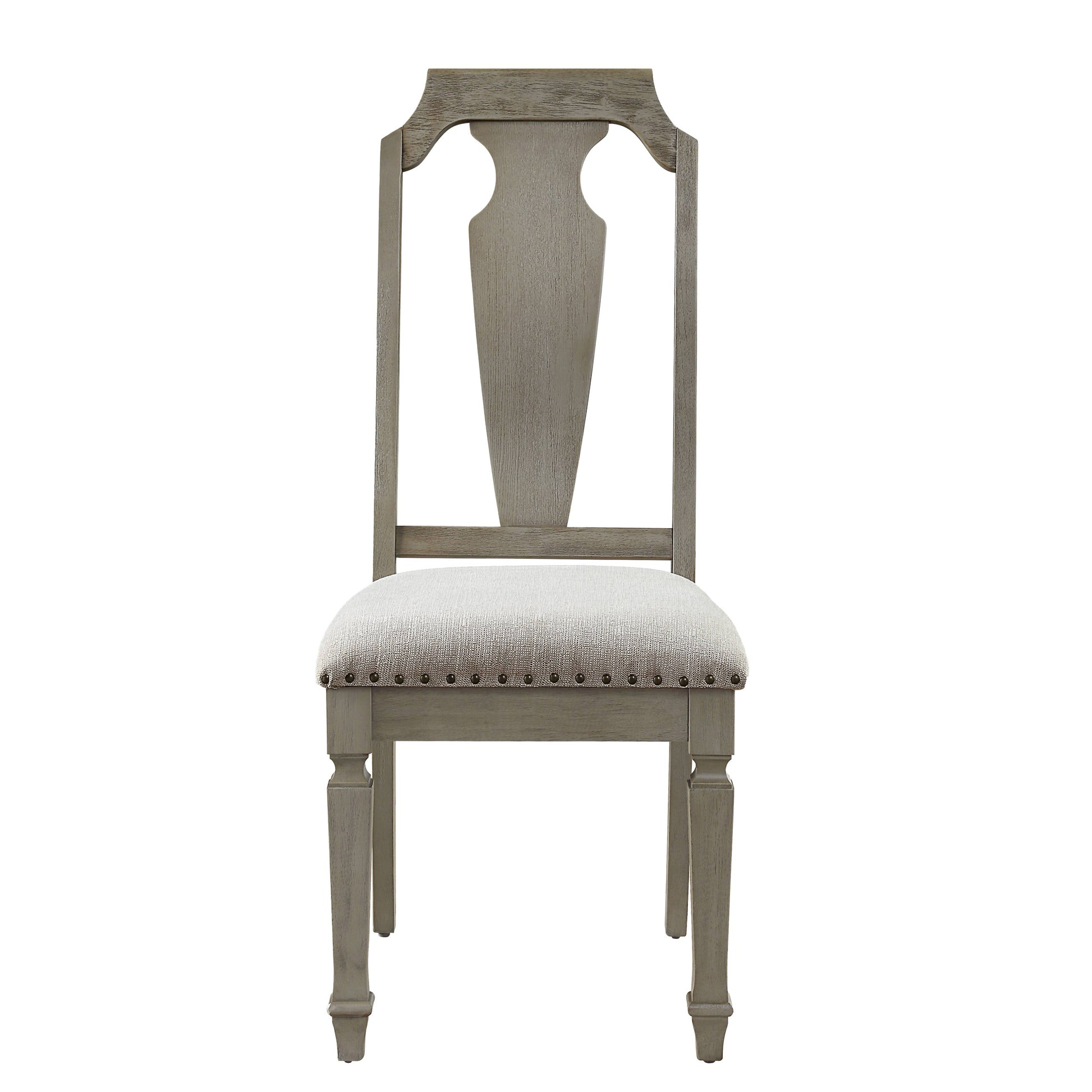 Gray upholstered dining chair with carved back details and antique nailhead trim