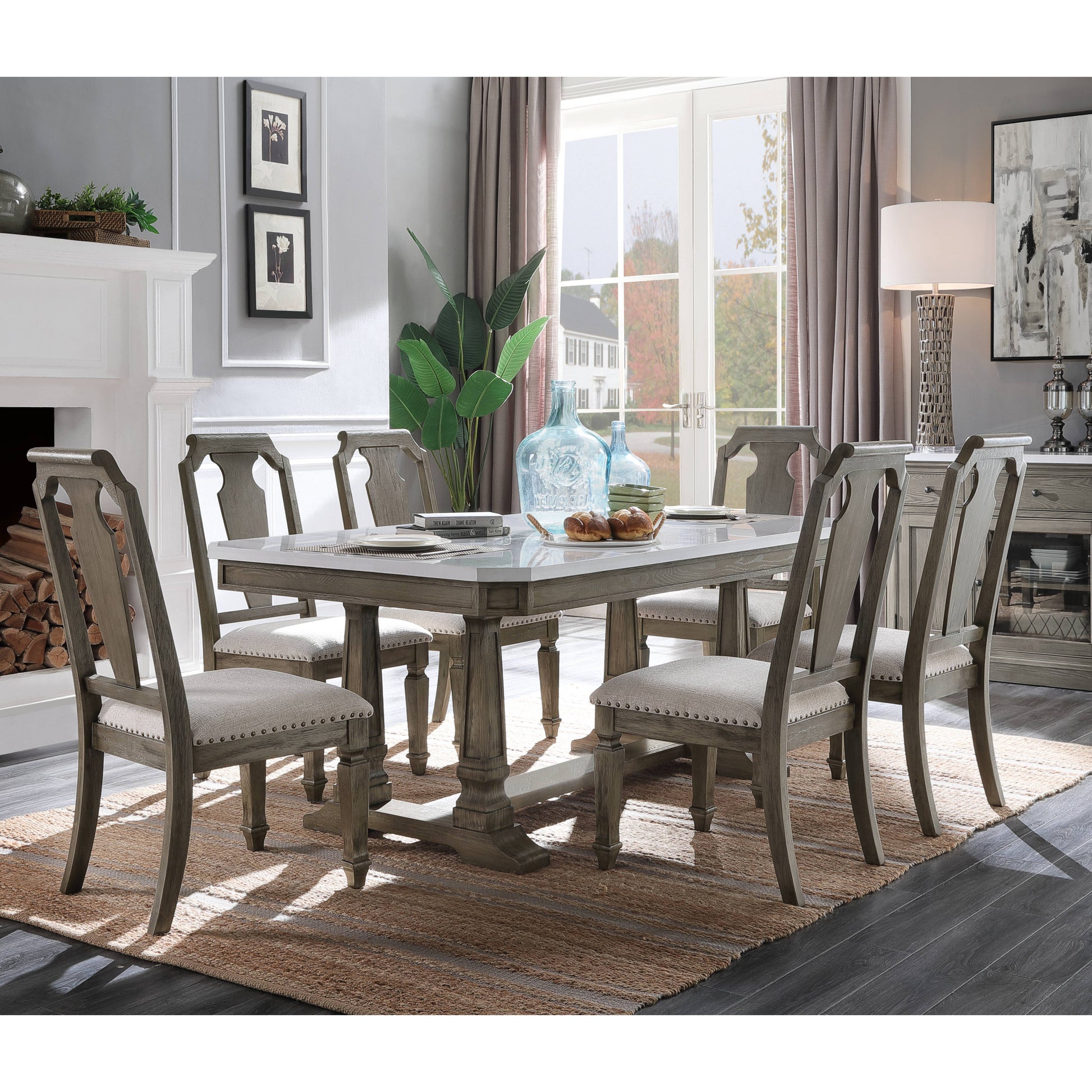 Gray wood dining table with marble top and upholstered chairs seating six for family meals
