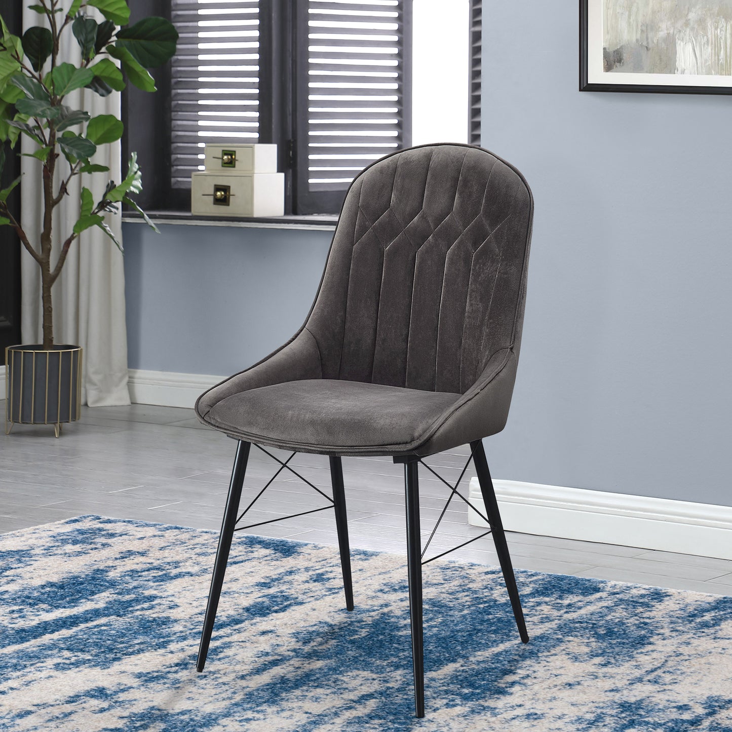 Dark gray velvet accent chair with quilted diamond pattern and black metal legs