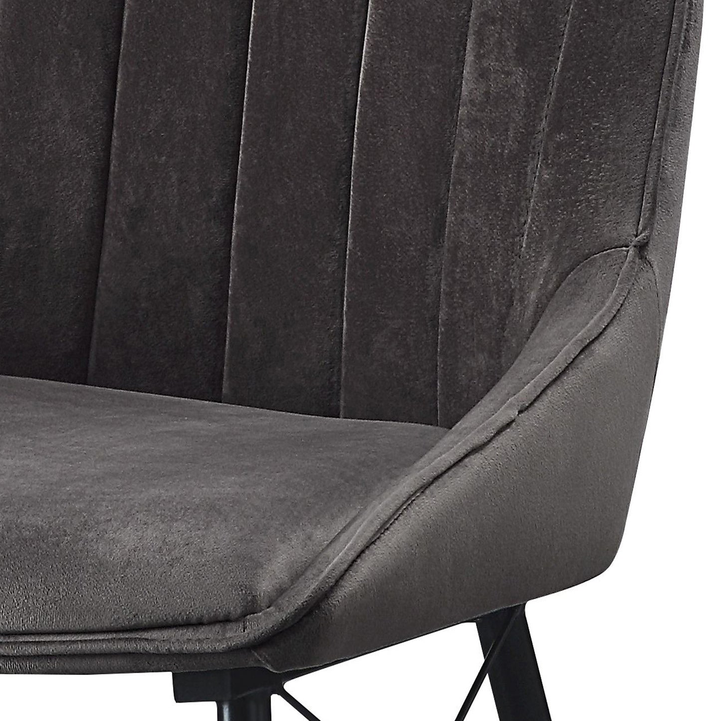 Close up of a dark gray upholstered dining chair with vertical channel tufting