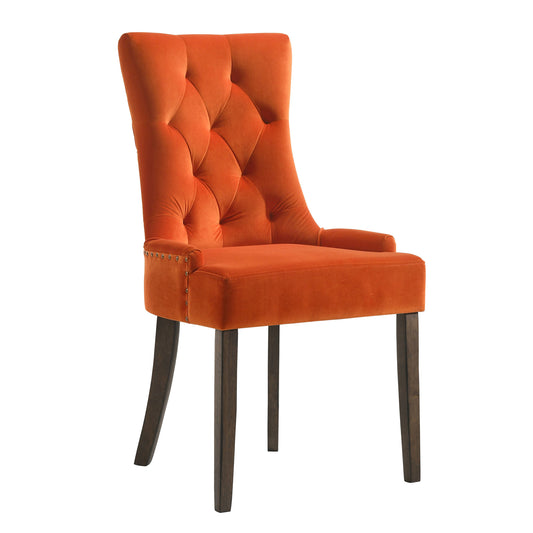 Orange velvet armchair with diamond tufting and dark wood legs