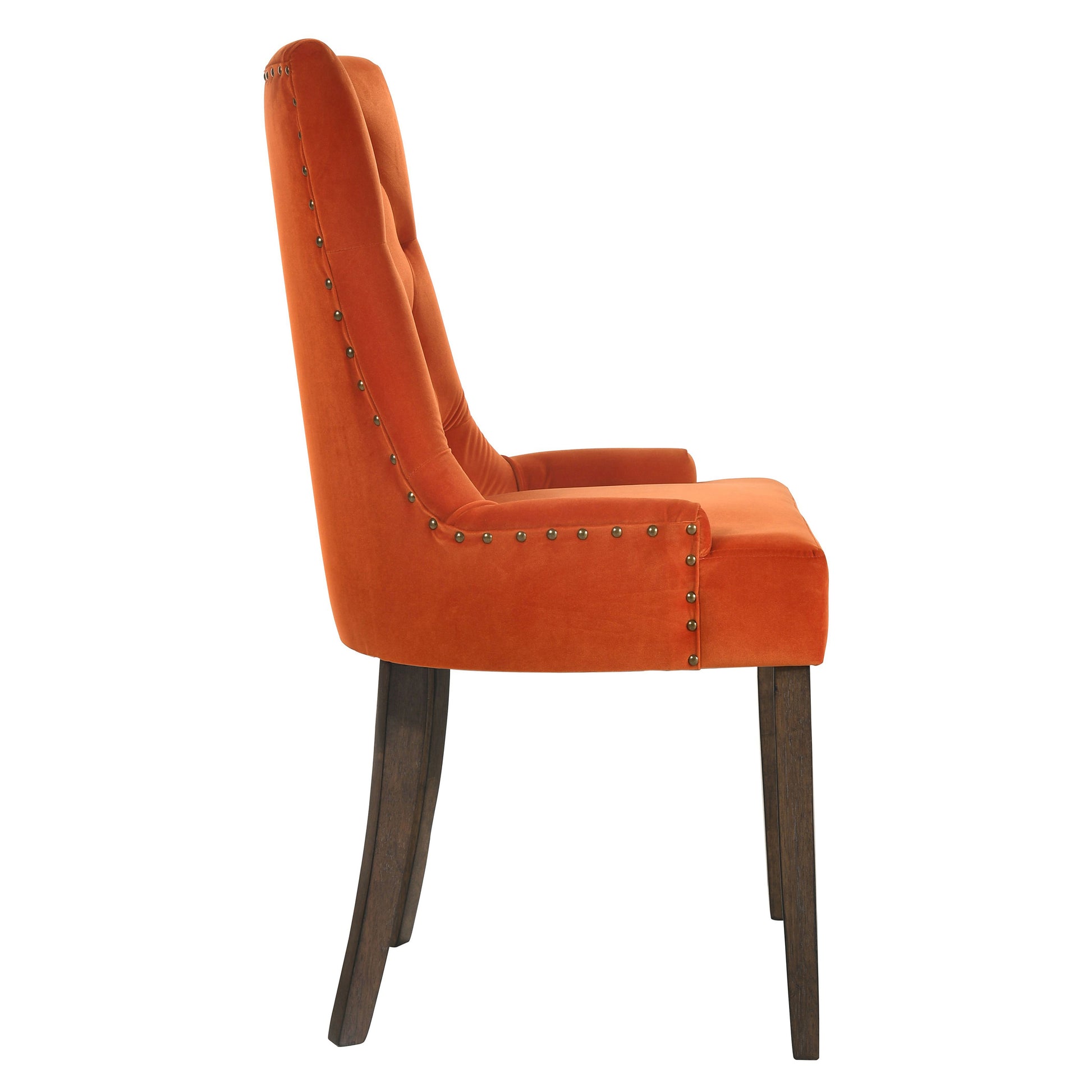 Orange velvet tufted dining chair with dark wood legs and brass nailhead trim