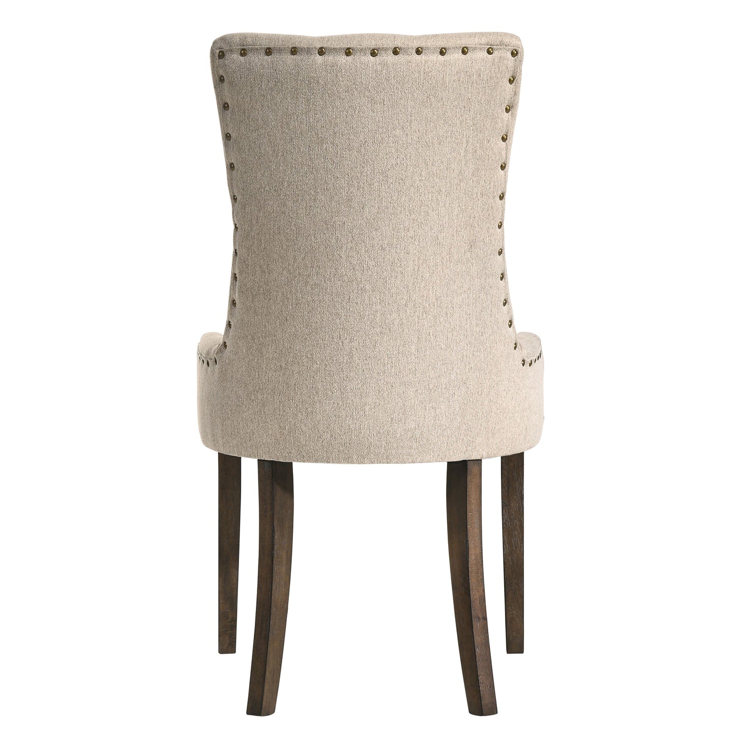 Back view of a beige upholstered dining chair with brass nailhead trim and dark wood legs