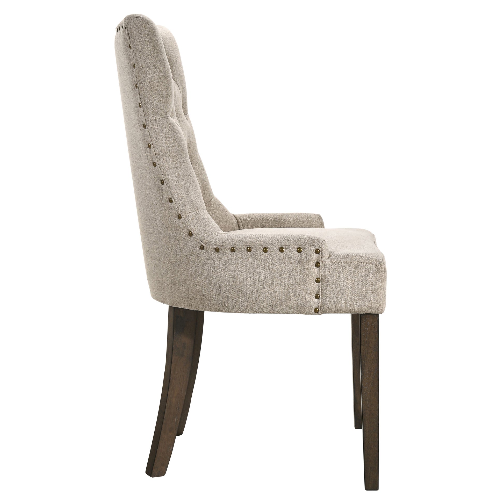 Tufted back linen dining chair in beige with brass nailhead trim and dark wood legs