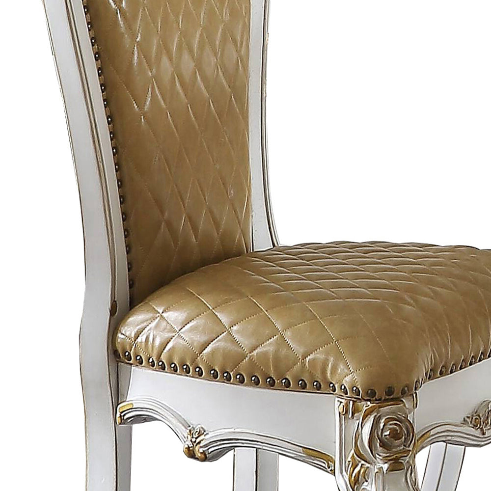 Tufted tan leather dining chair with ornate white and gold trim