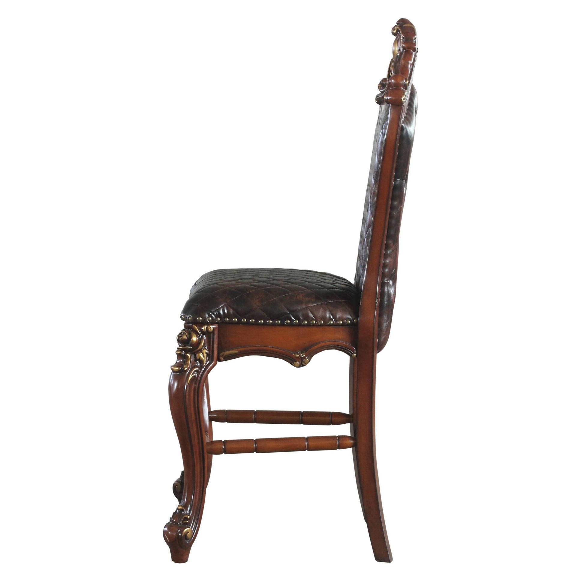Elegant tufted leather dining chair with mahogany wood frame and ornate detailing