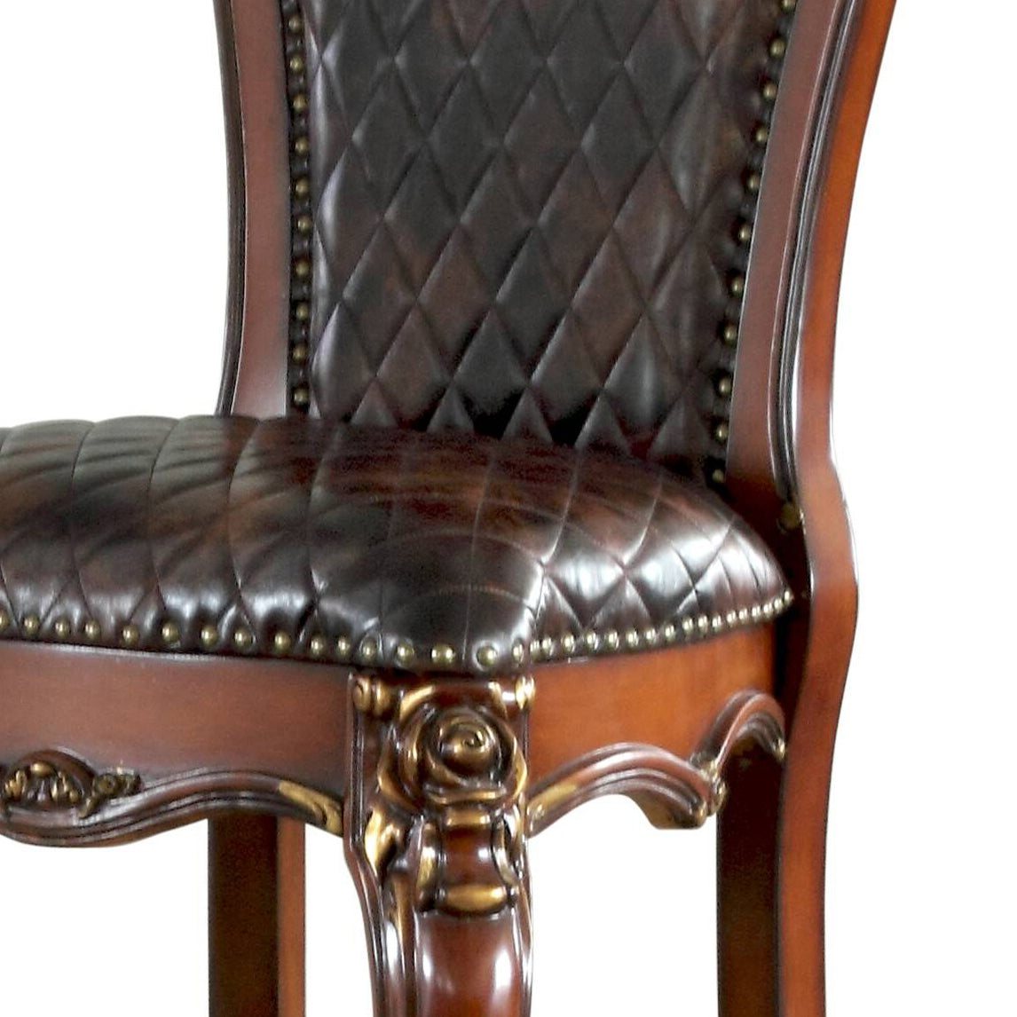 Diamondtufted dark brown leather armchair with ornate wood carvings and brass nailhead trim