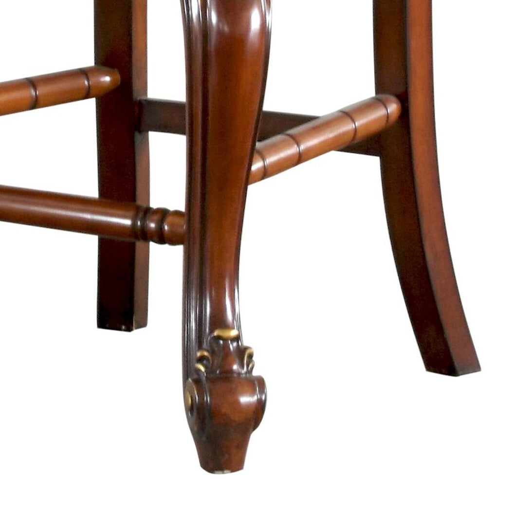 Ornate mahogany wooden chair leg with carved gold accent details