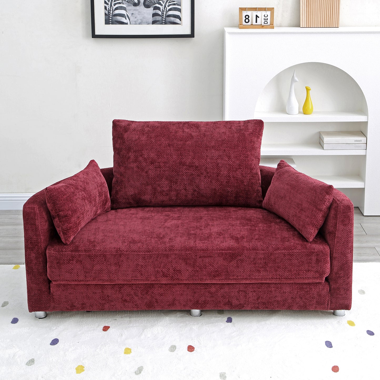 Textured burgundy loveseat with plush throw pillows and sleek metal legs
