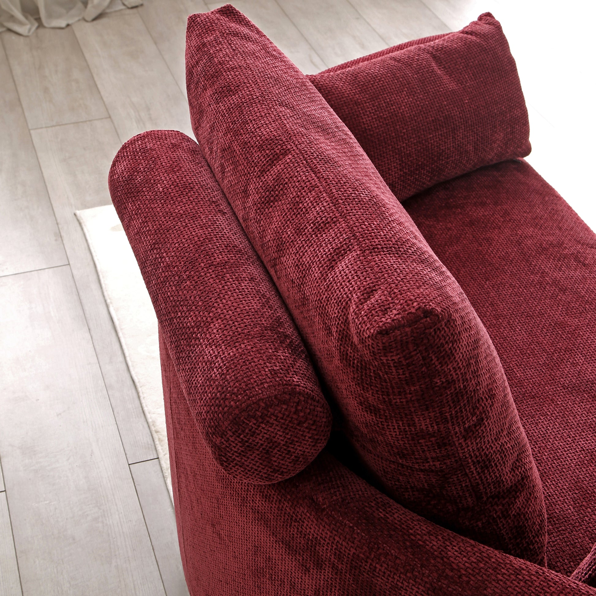 Plush red fabric sectional sofa with textured upholstery and comfortable throw pillows for living rooms