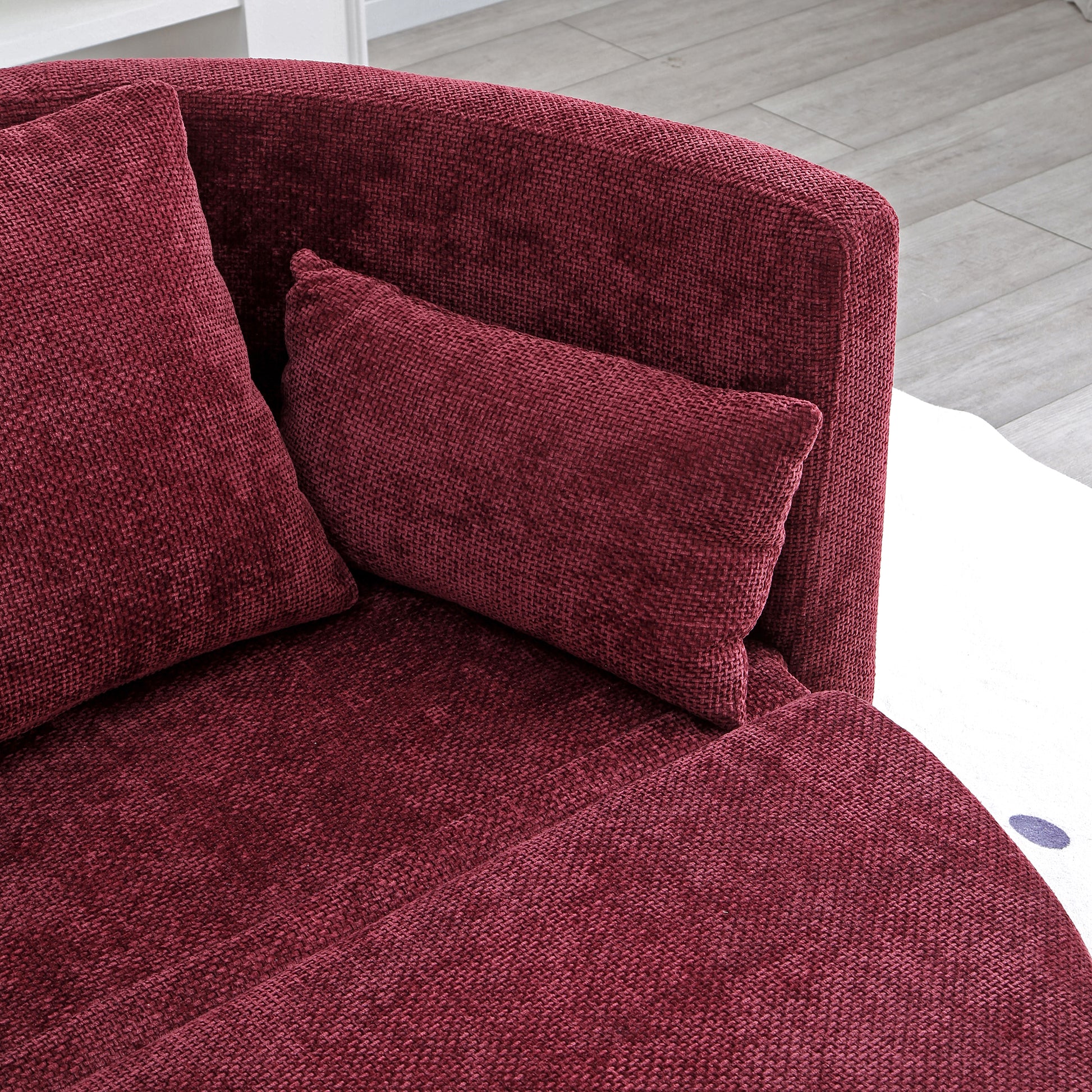 Deep red textured fabric sofa with plush accent pillows for comfortable living room seating