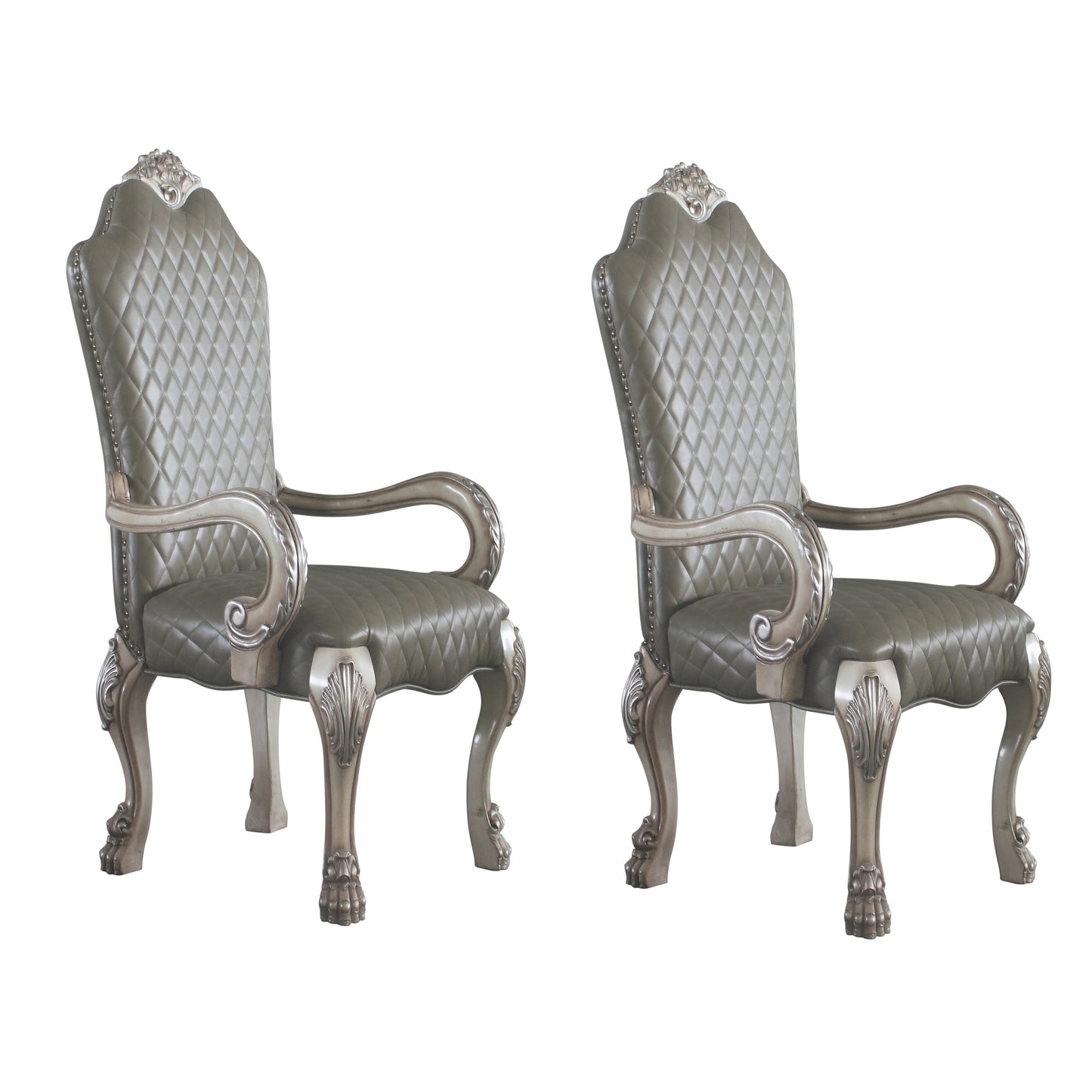 Two ornate tufted grey leather accent chairs with antique silver carved legs and arms