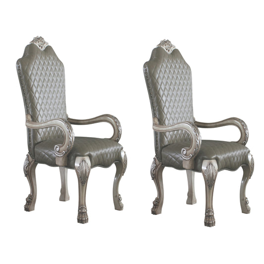 Two ornate tufted grey leather accent chairs with antique silver carved legs and arms