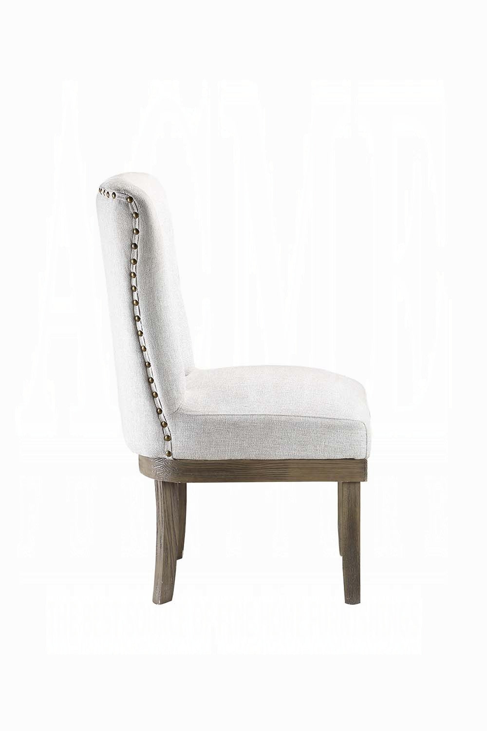 Upholstered accent chair in light grey linen with nailhead trim and distressed wood legs