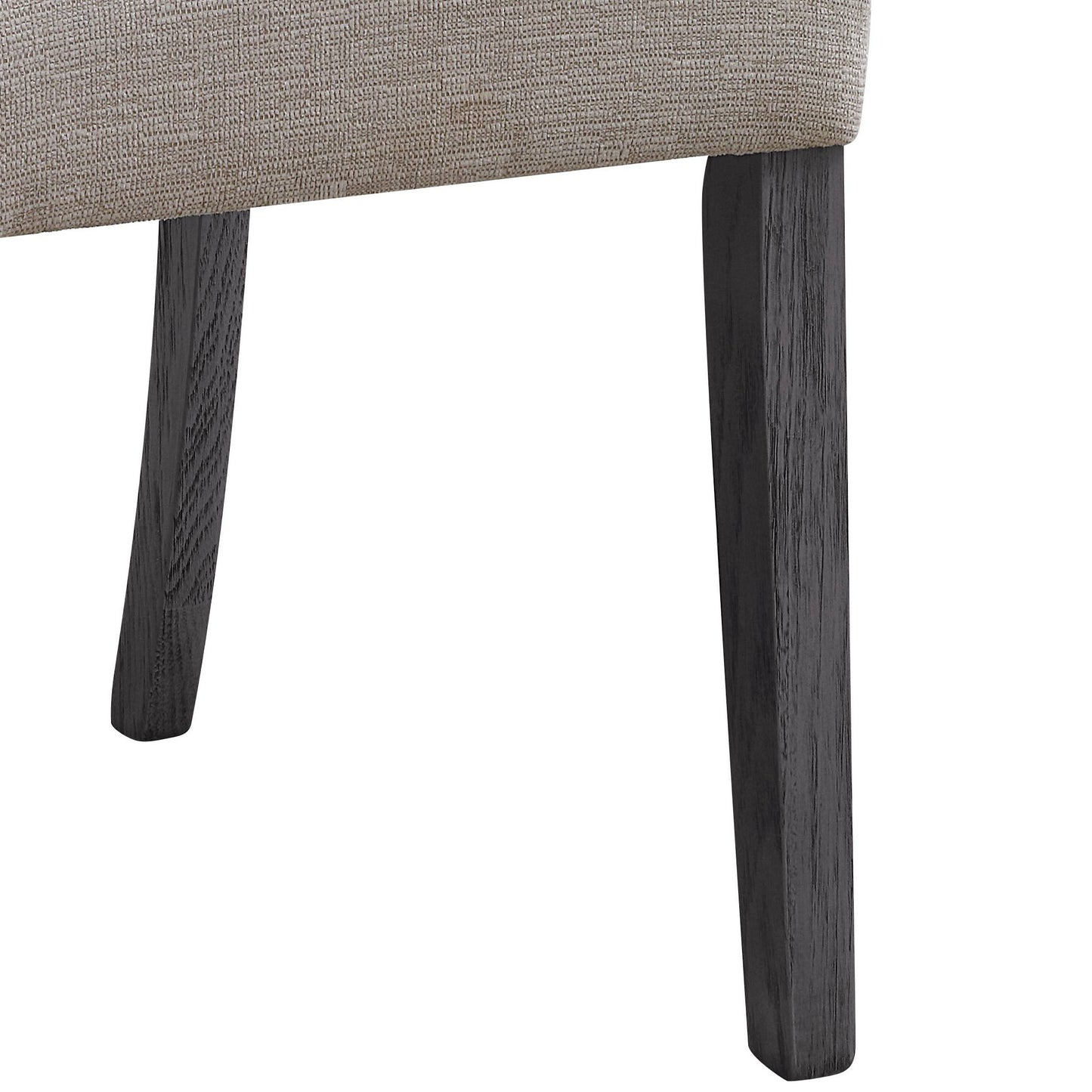 Closeup of a textured beige upholstered chair leg with dark oak wood finish