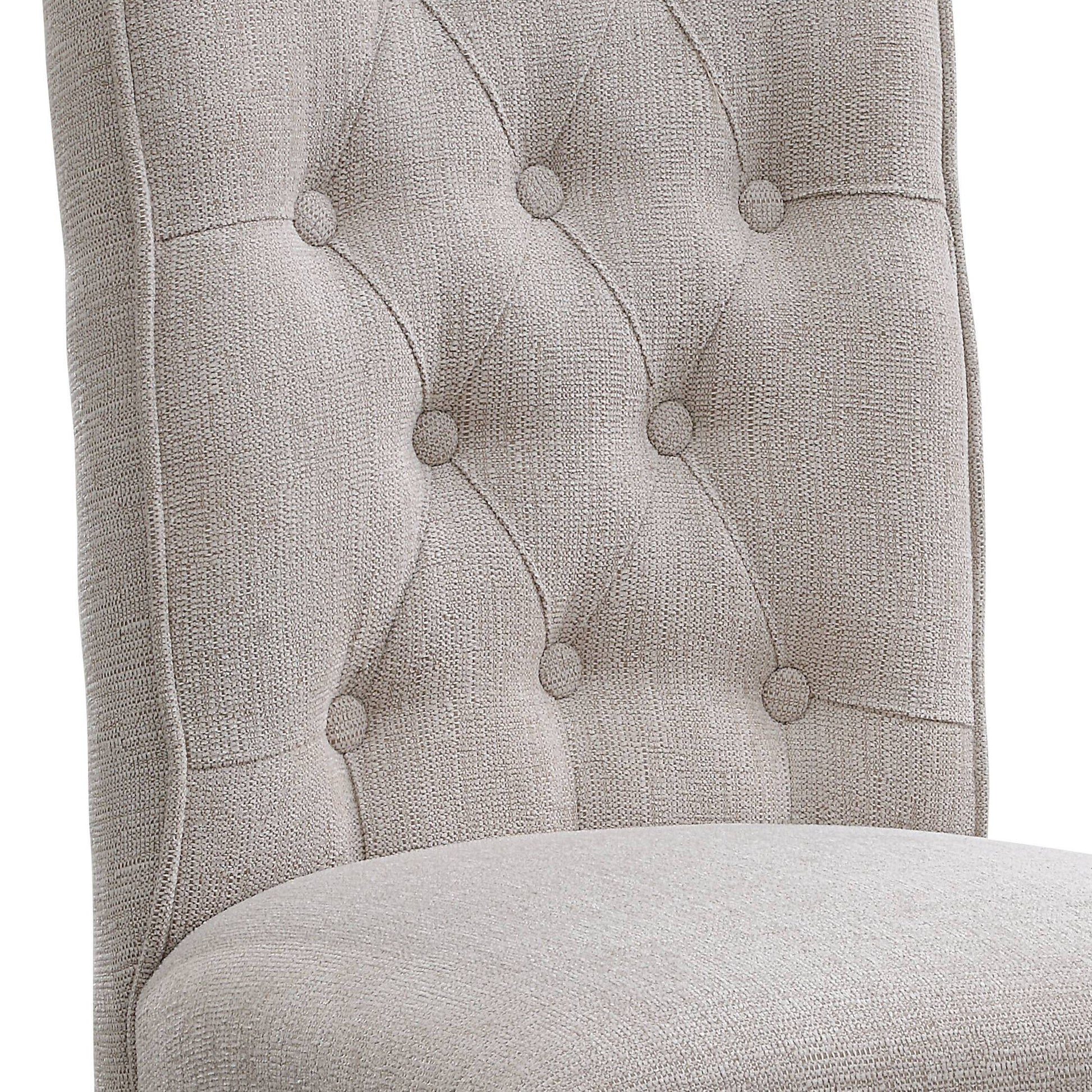 Closeup of a tufted beige fabric dining chair back with button details