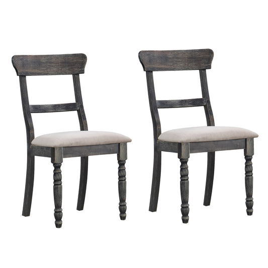 Two distressed gray wooden dining chairs with light beige upholstered seats