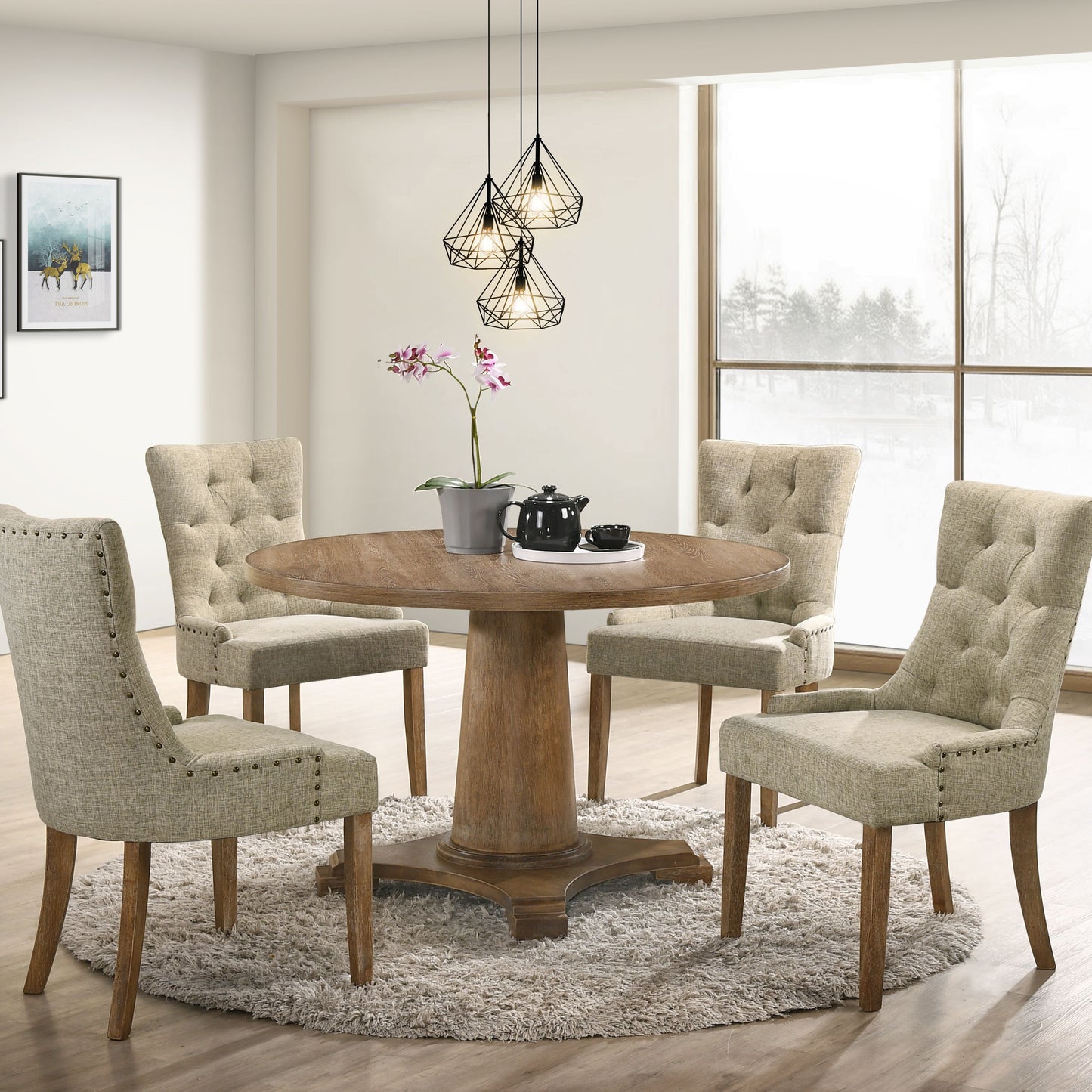 Round pedestal dining table with four tufted upholstered chairs and decorative nailhead trim