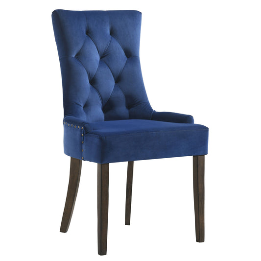 Navy blue velvet tufted dining chair with brass nailhead trim and dark wood legs