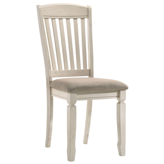 White wooden dining chair with upholstered seat and slatted backrest