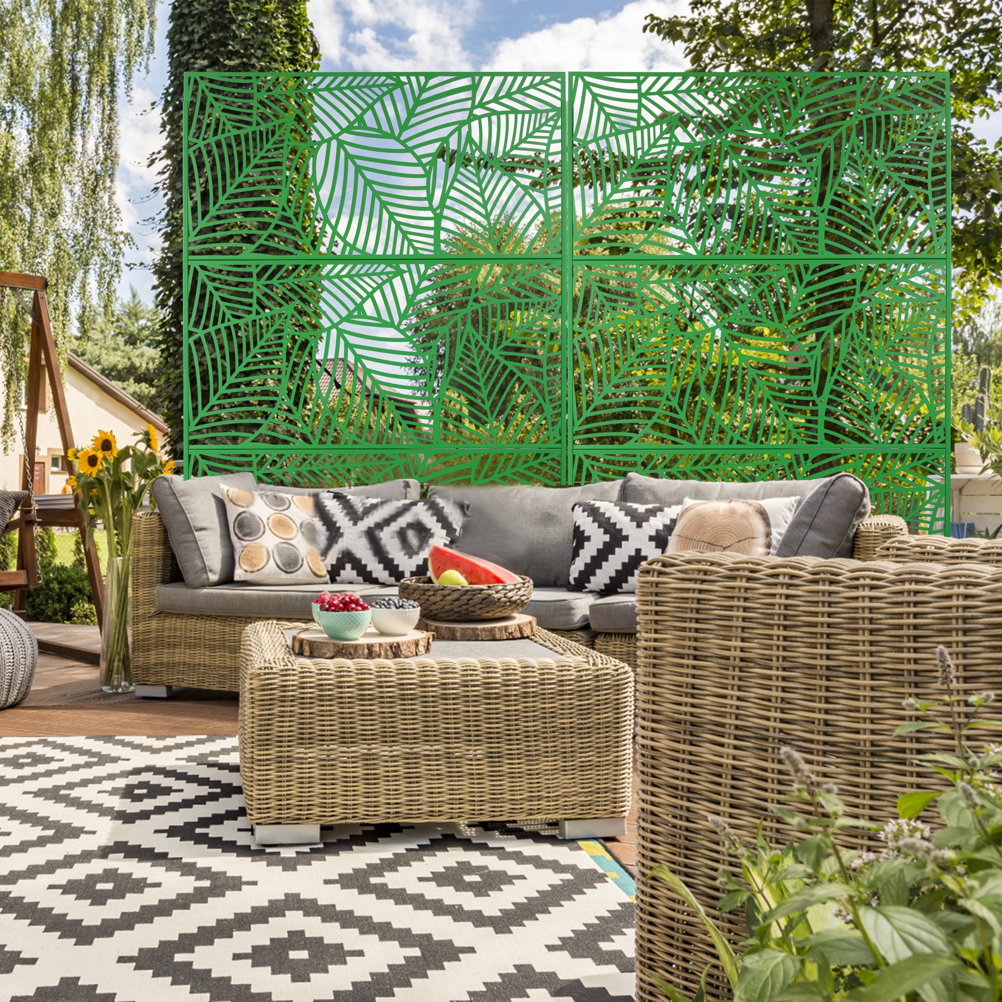 Green decorative garden screen with lasercut leaf pattern for outdoor privacy