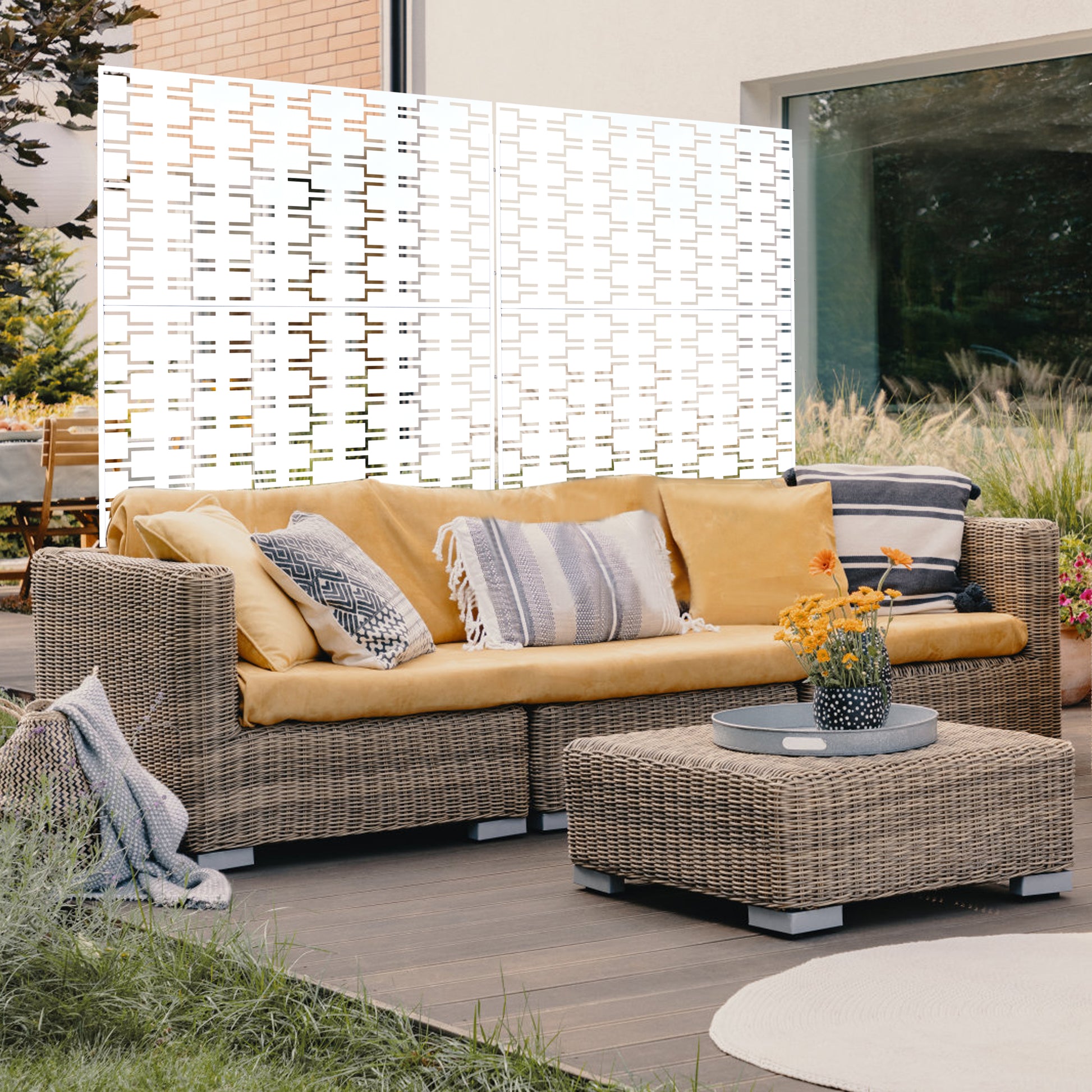 Wicker sectional sofa with mustard cushions and decorative throw pillows on a patio deck