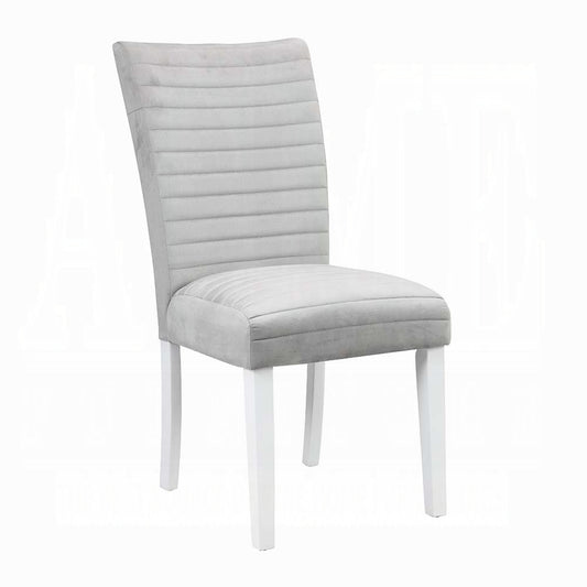 Light gray upholstered dining chair with horizontal stitching and white wooden legs
