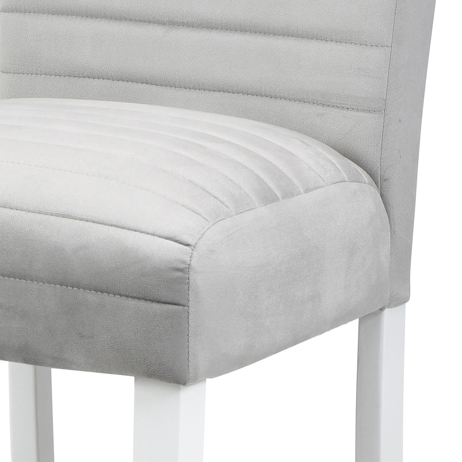 Close up of a light grey upholstered bar stool with subtle channel tufting