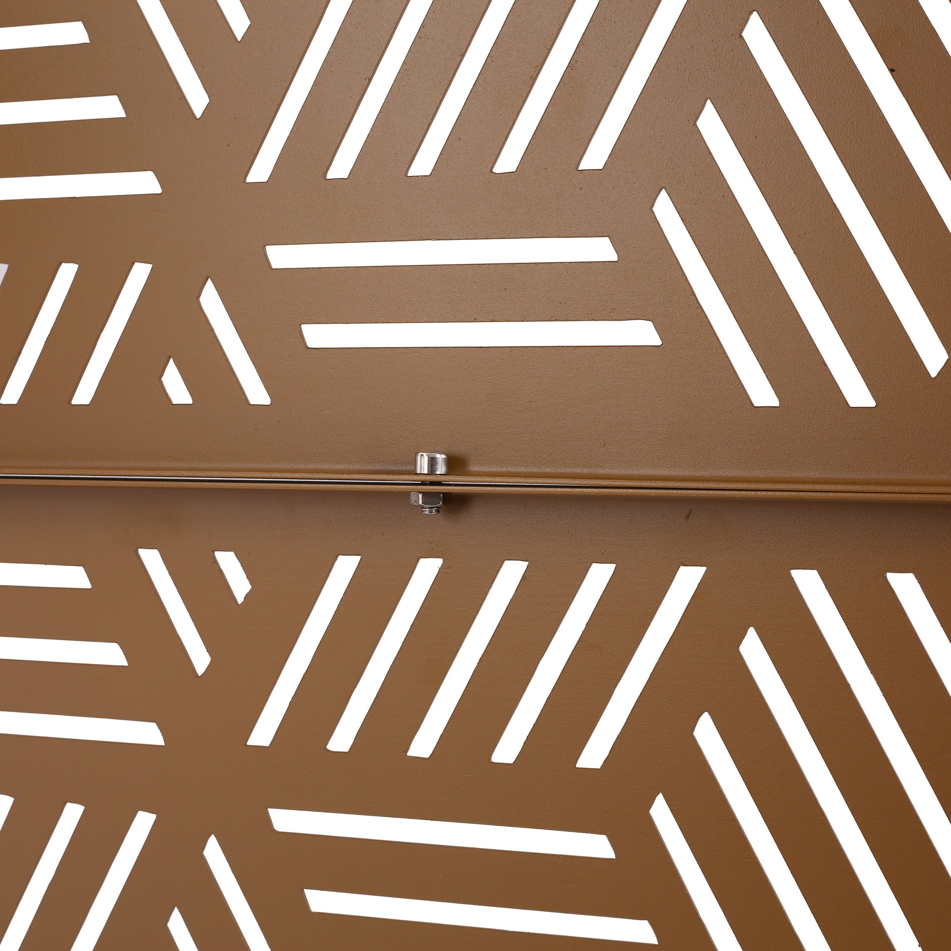 Bronze metal decorative screen with geometric cutouts and visible bolt detail
