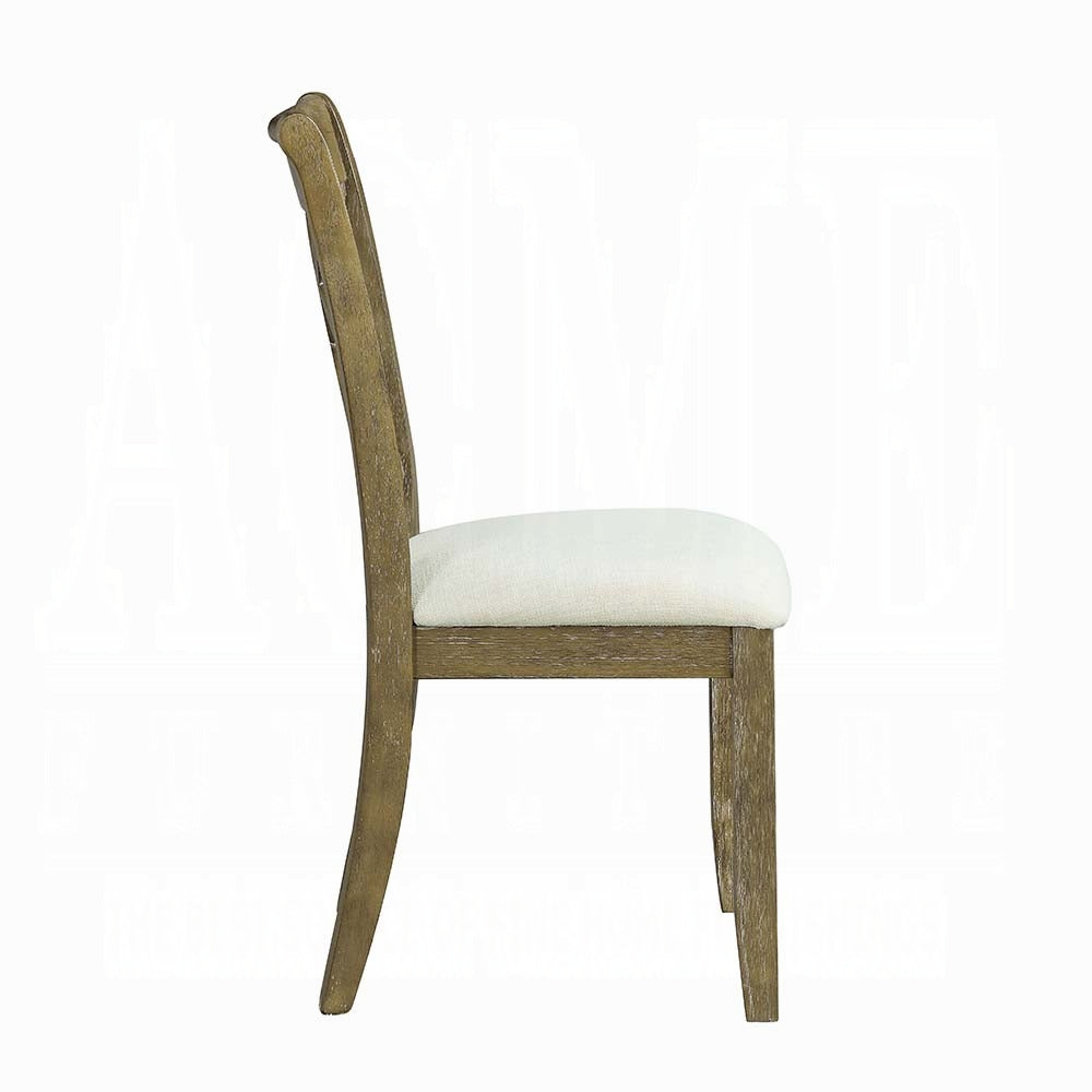 Side profile of a distressed wood dining chair with an offwhite linen seat