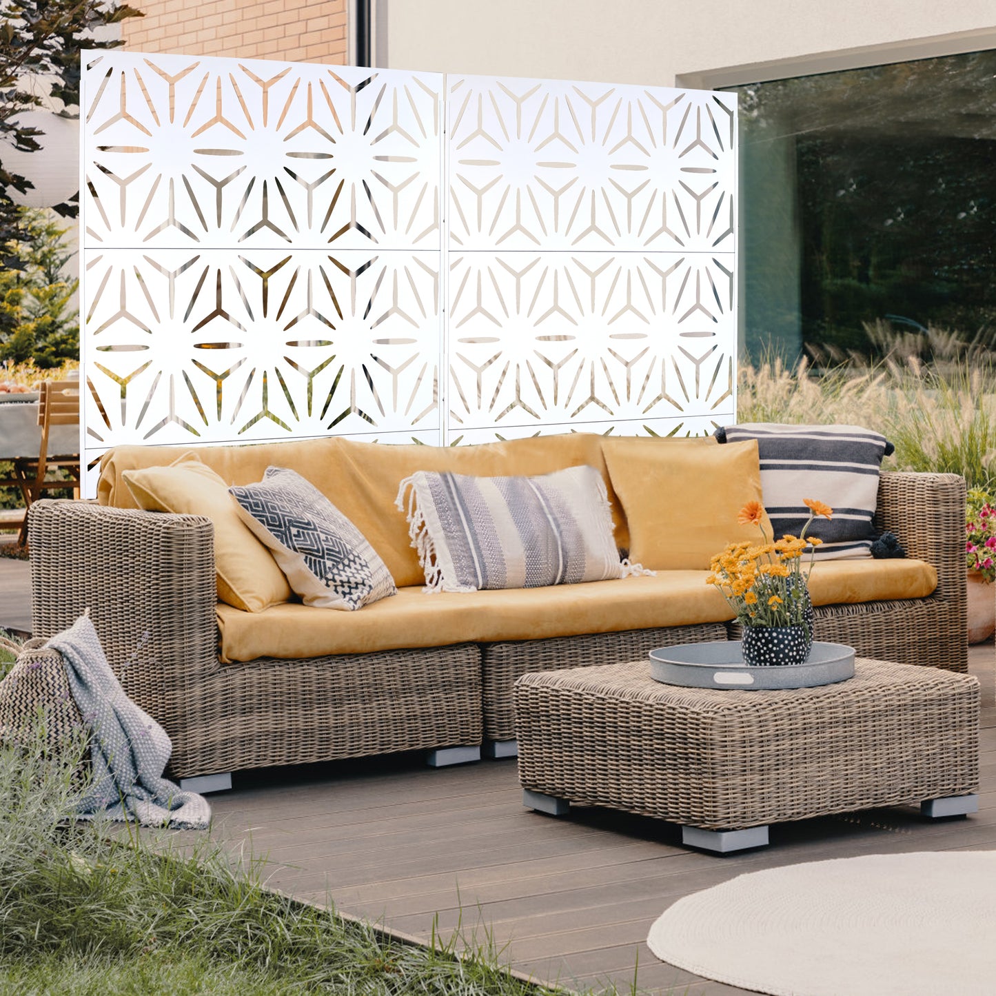 Wicker sectional sofa with yellow cushions and geometric white outdoor screen
