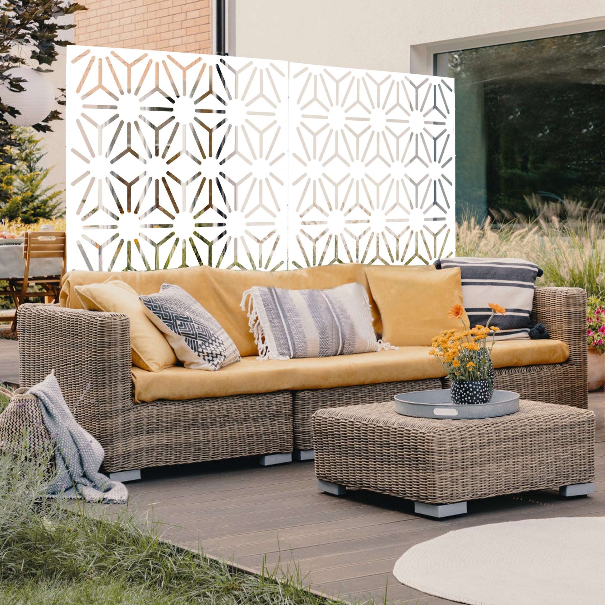 White geometric outdoor privacy screen with intricate starburst pattern