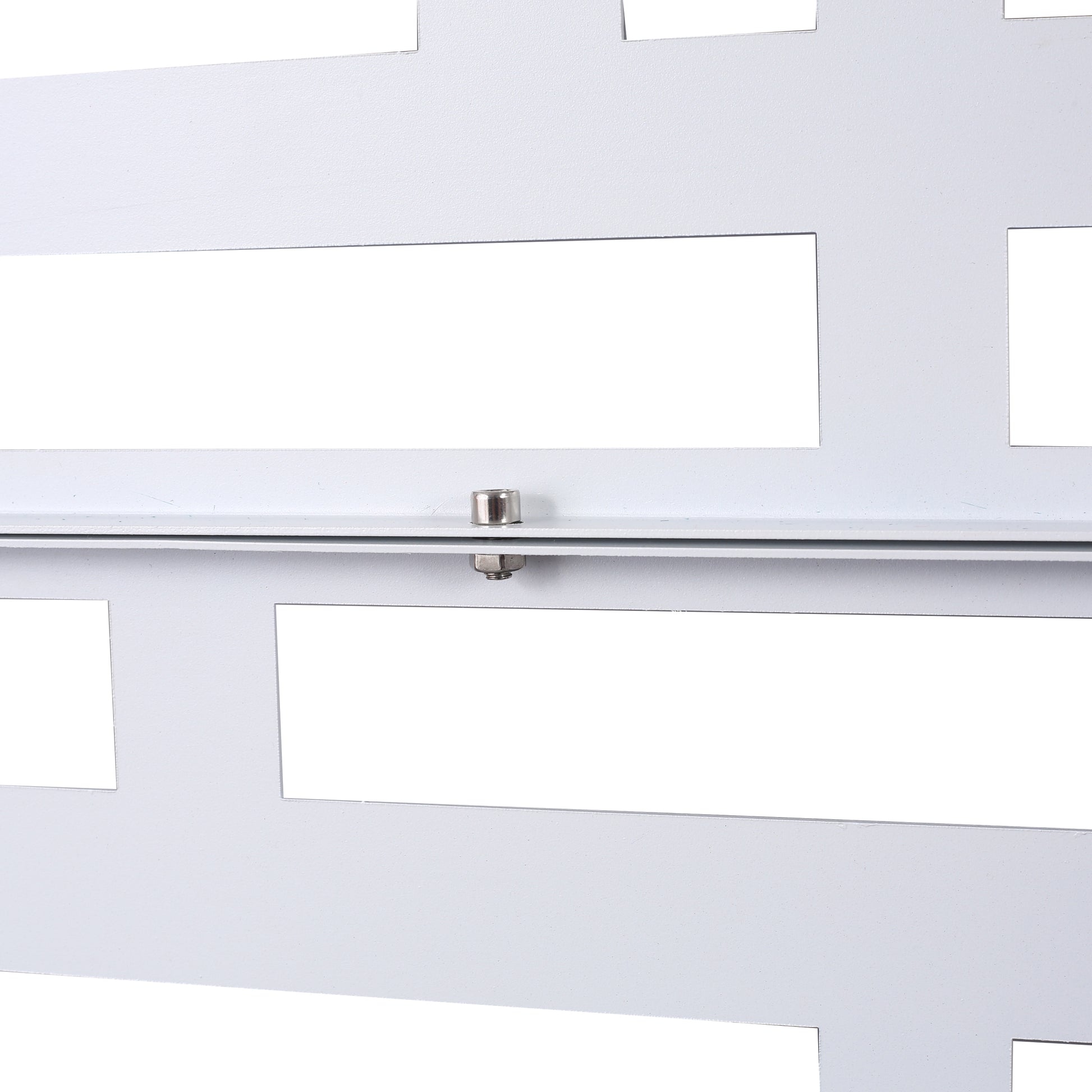 White metal decorative panel with geometric cutouts and visible screw fastener