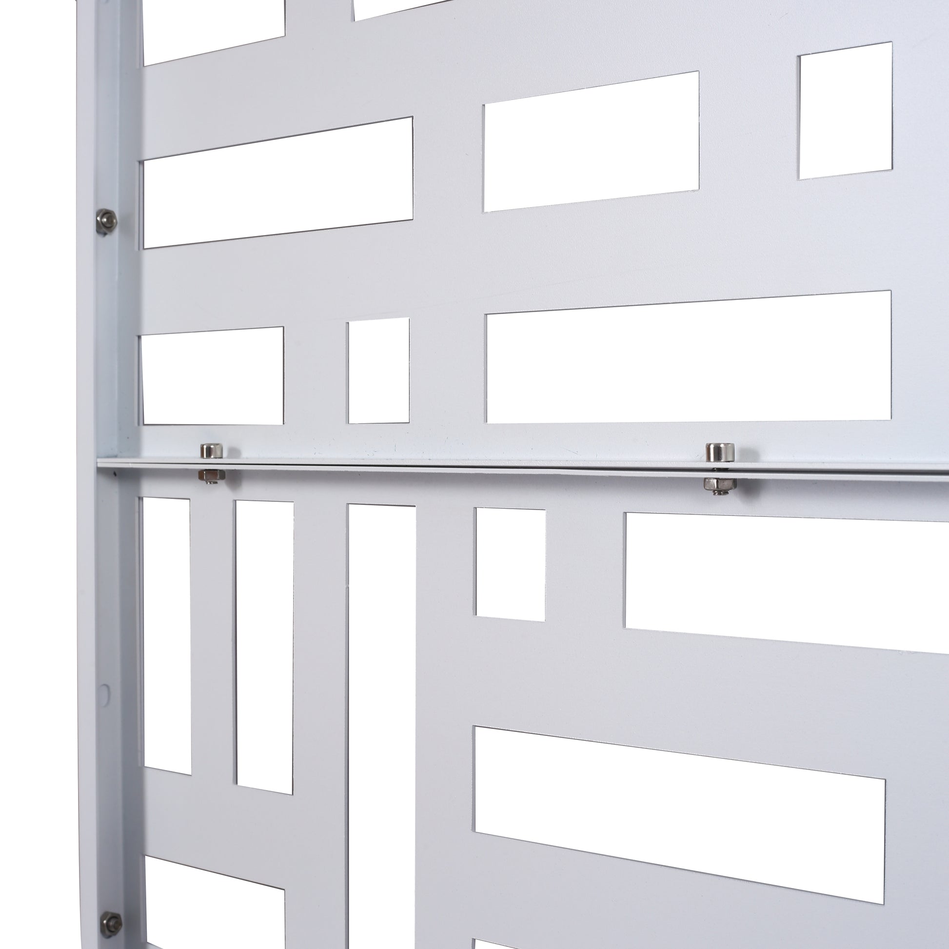 Close up of a white metal decorative screen with geometric cutouts suitable for indoor or outdoor privacy