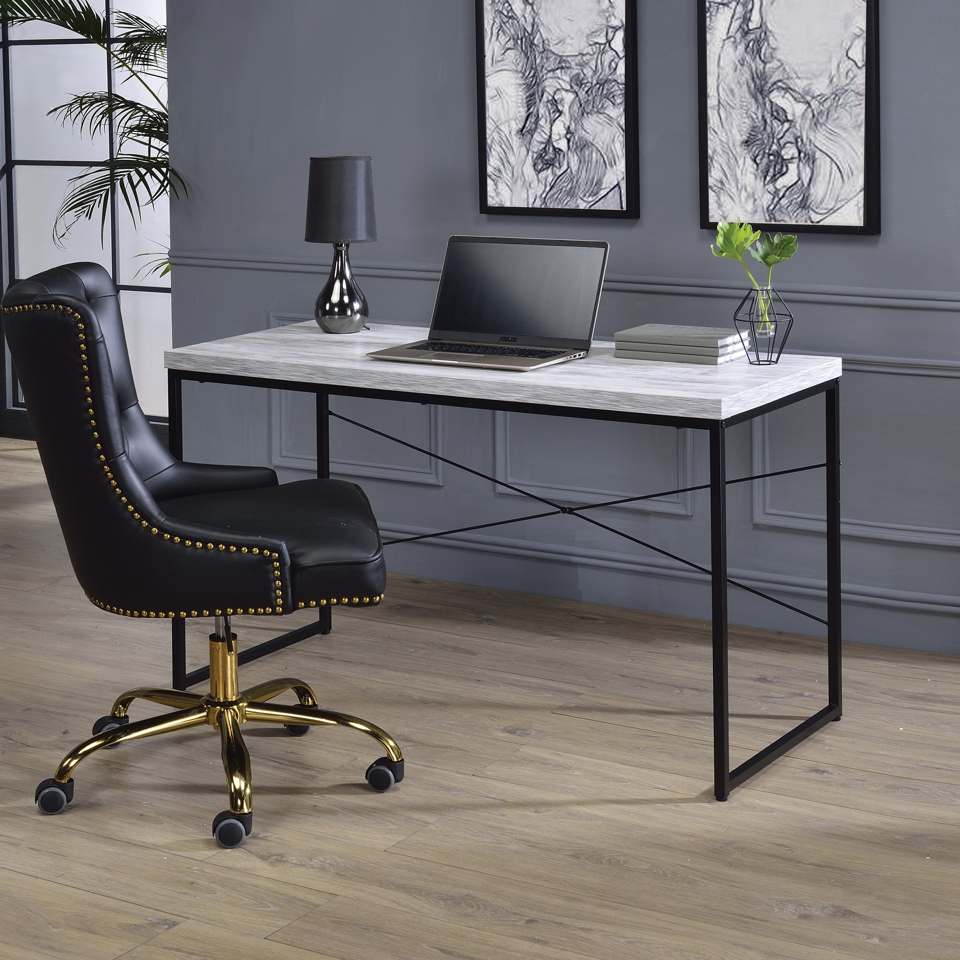 Black leather executive chair with gold accents and caster wheels