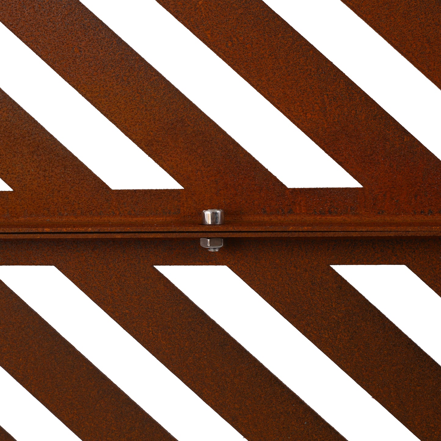 Closeup of rusted metal garden screen with diagonal white cutouts