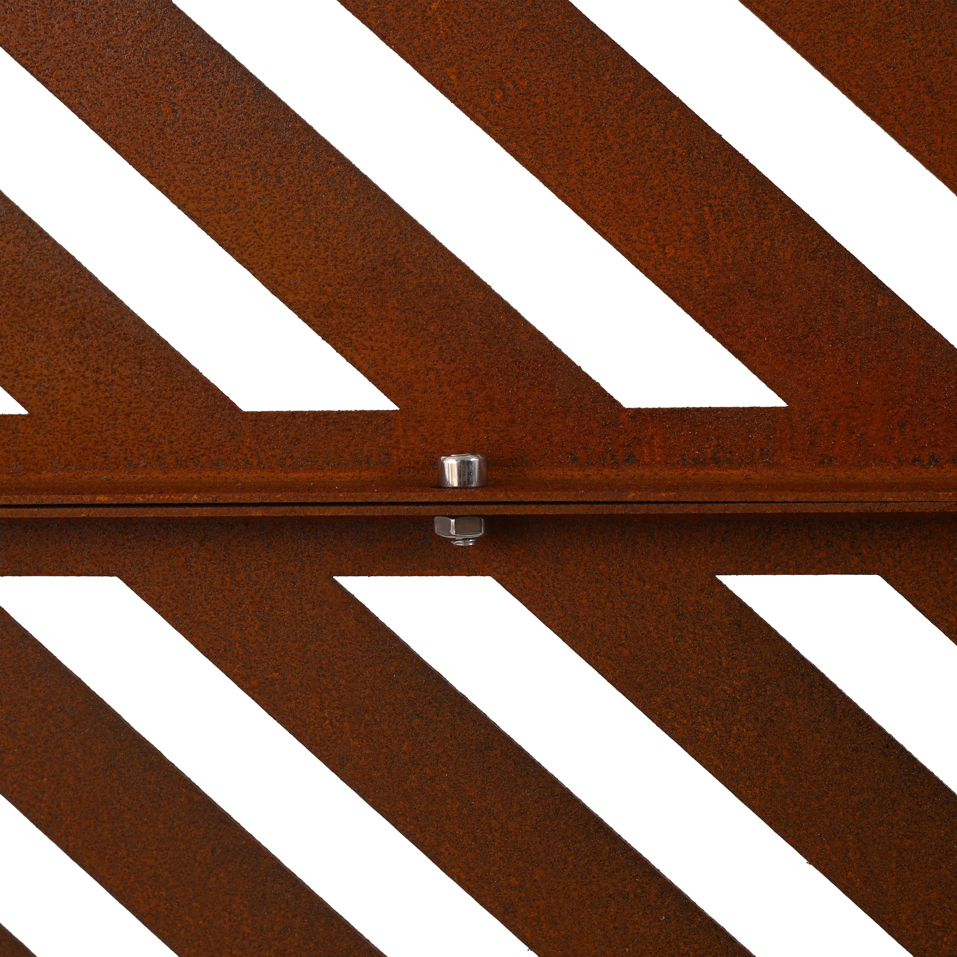 Closeup of rusted metal garden screen with diagonal white cutouts