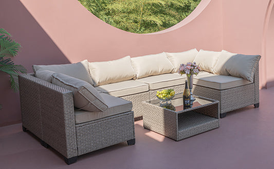 Sectional wicker outdoor sofa with beige cushions perfect for patio relaxation