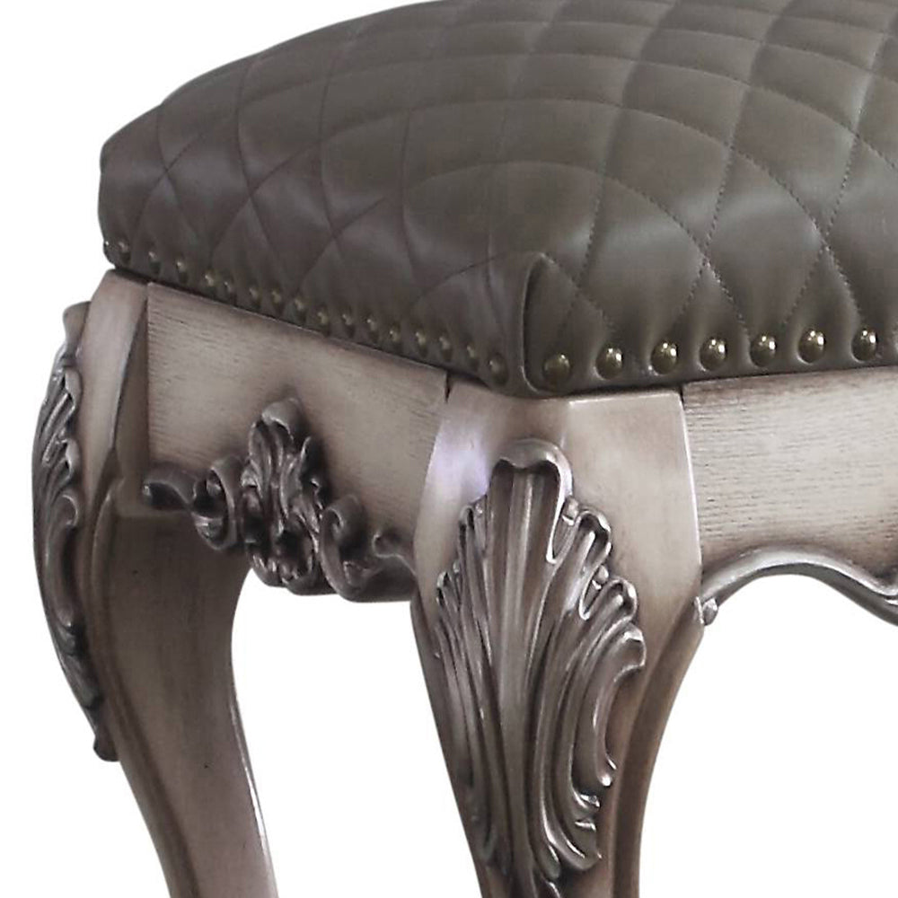 Quilted grey leather vanity stool with ornate carved wooden legs