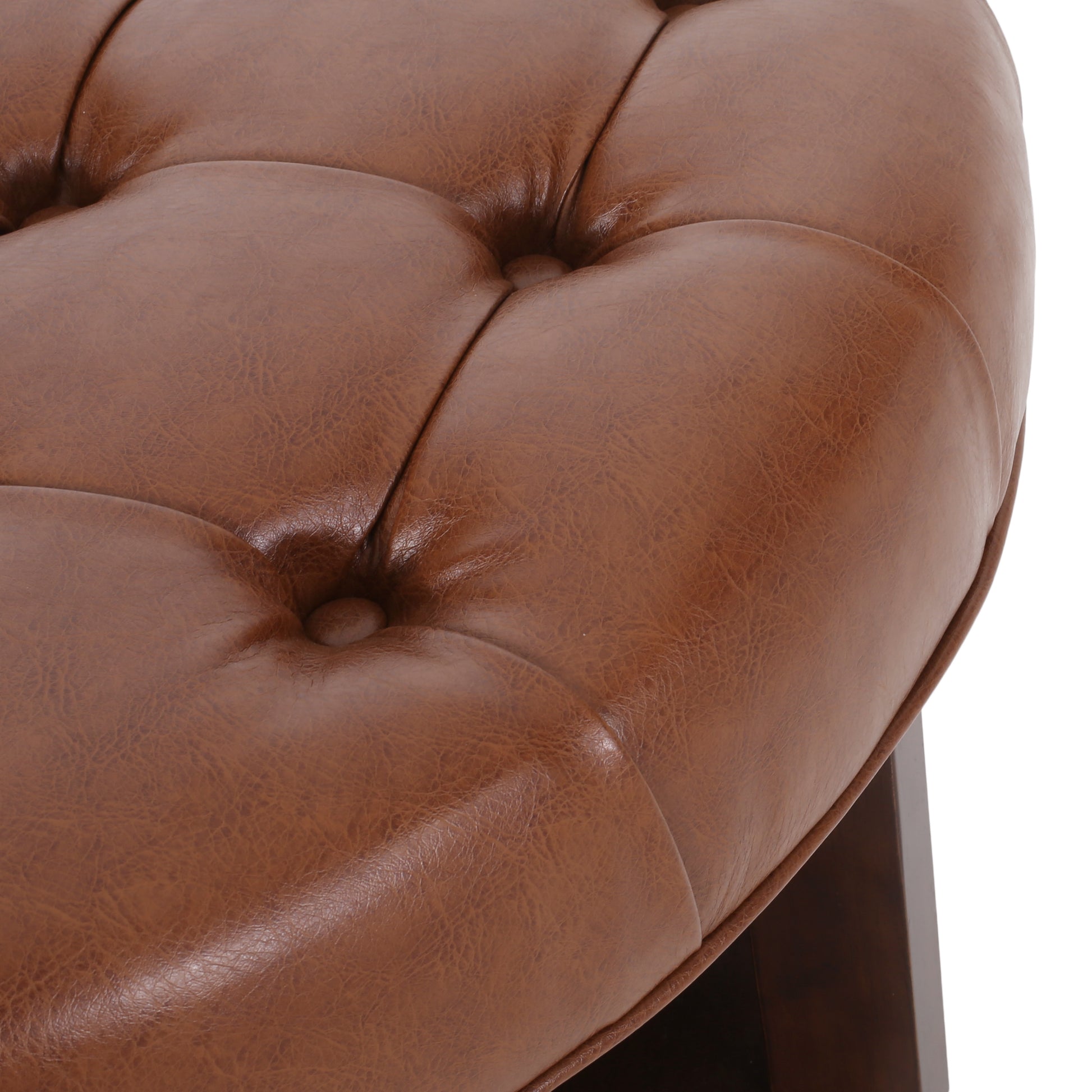 Brown tufted faux leather ottoman detail