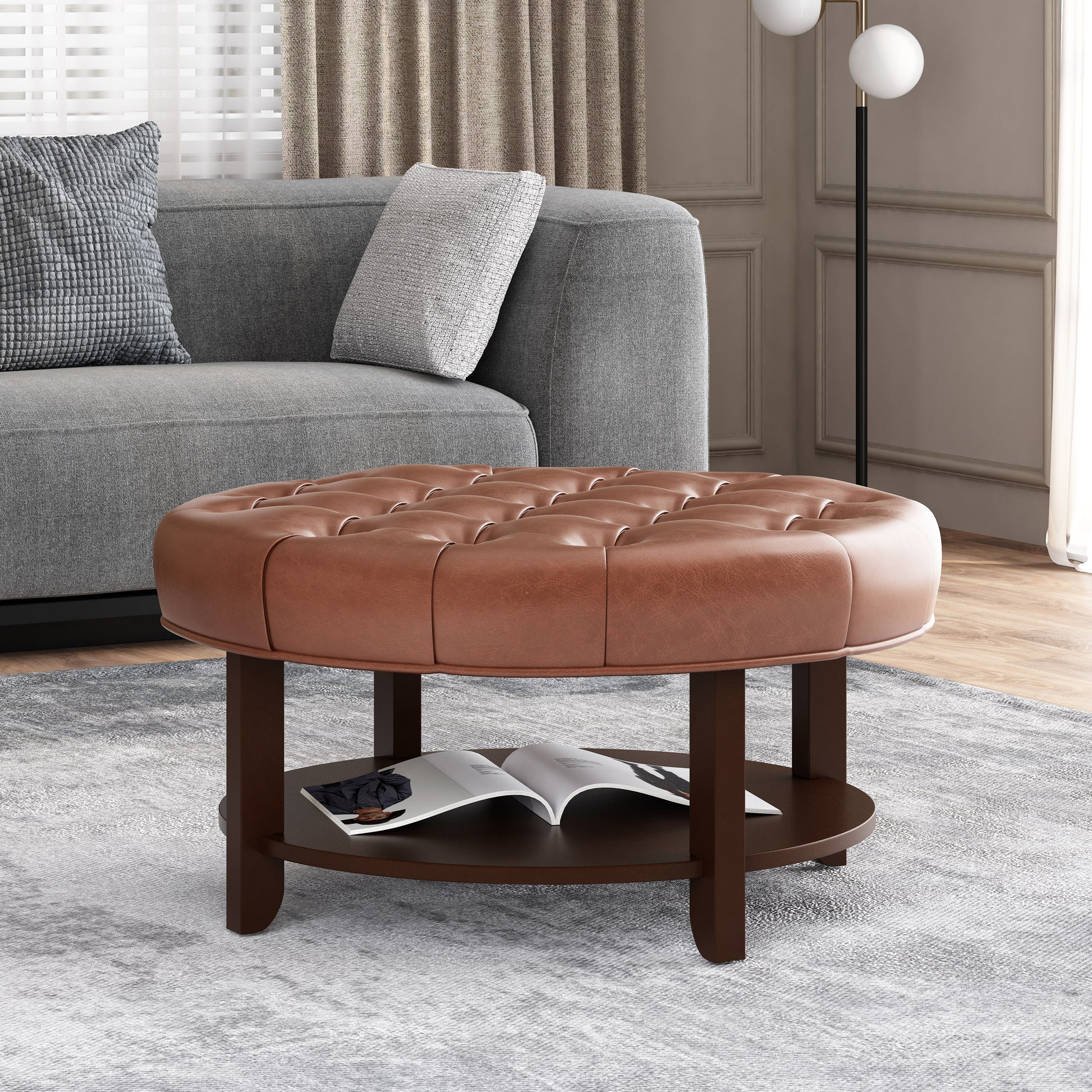 Tufted brown leather round ottoman with dark wood base and lower shelf