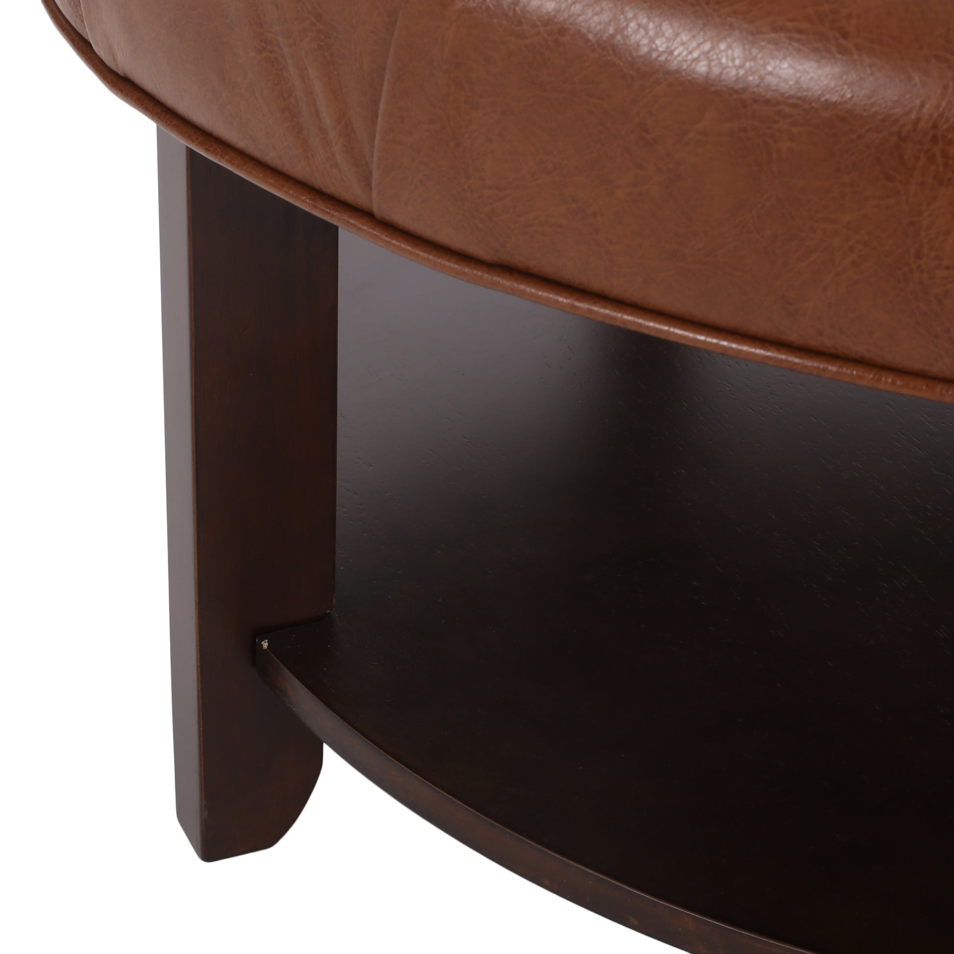 Brown leather tufted ottoman with dark wood legs